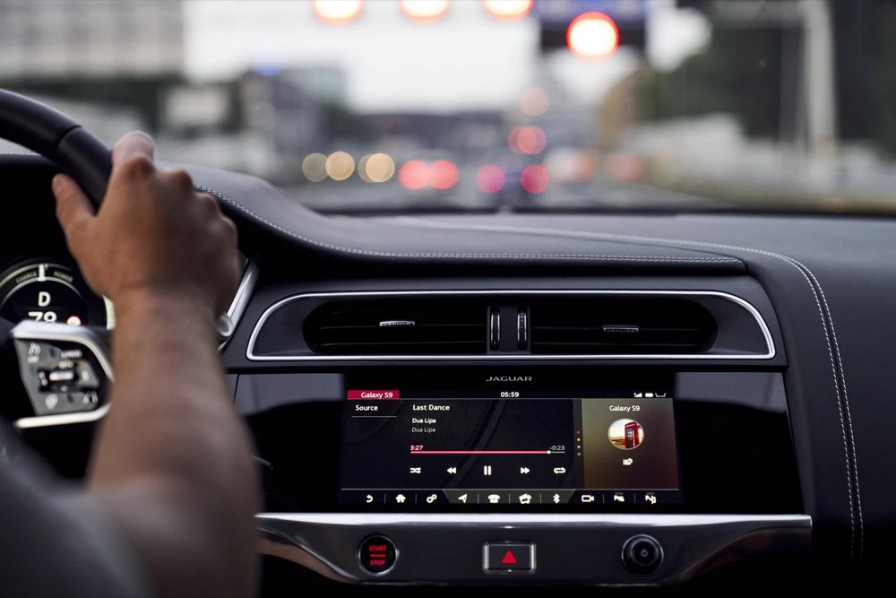 Hände am Lenkrad des roten Jaguar I-PACE, Innenaufnahme