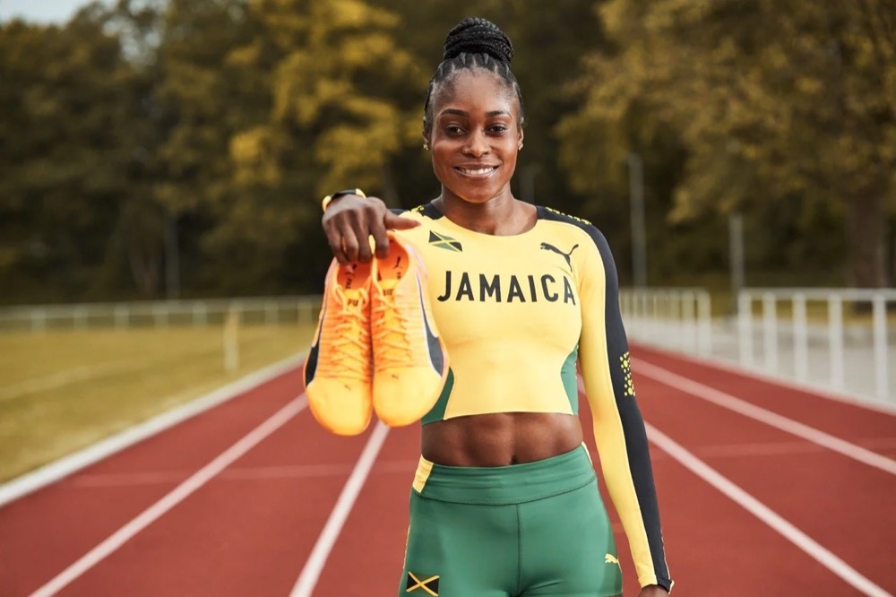 Elaine Thompson-Herah im Jamaika-Trikot mit Puma-Fireglow-Spikes auf einer Laufbahn